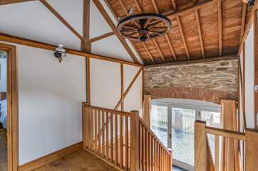The entrance hall is on the first floor and accessed via the main courtyard. Both bedrooms sit either side, with the main open plan living area being on the lower level.