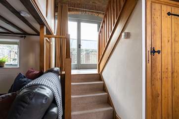 The stairs links the house together, with the back patio accessed via the middle landing and benefits from large glazed doors.