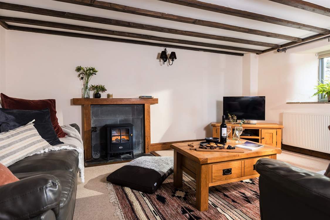 The living-room is warm and welcoming and situated on the lower floor of this beautifully converted barn. 