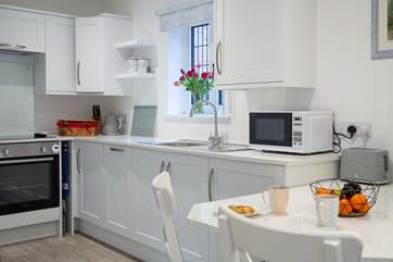 Rustle up your favourite meal in the fully equipped kitchen, with a seating area for two.
