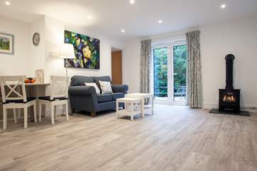 The contemporary open plan living area with a comfy sofa and armchair (due to arrive shortly photo to follow)