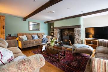 The fabulous sitting-room features a wood-burner to keep you toasty on those cooler days and evenings.