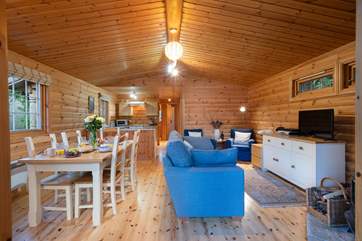 Attractive open plan kitchen, dining and living areas with wood-burner.