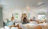 Light and spacious second sitting room with sea views and cosy wood-burner. - Thumbnail Image