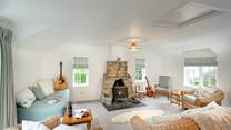 Light and spacious second sitting room with sea views and cosy wood-burner.