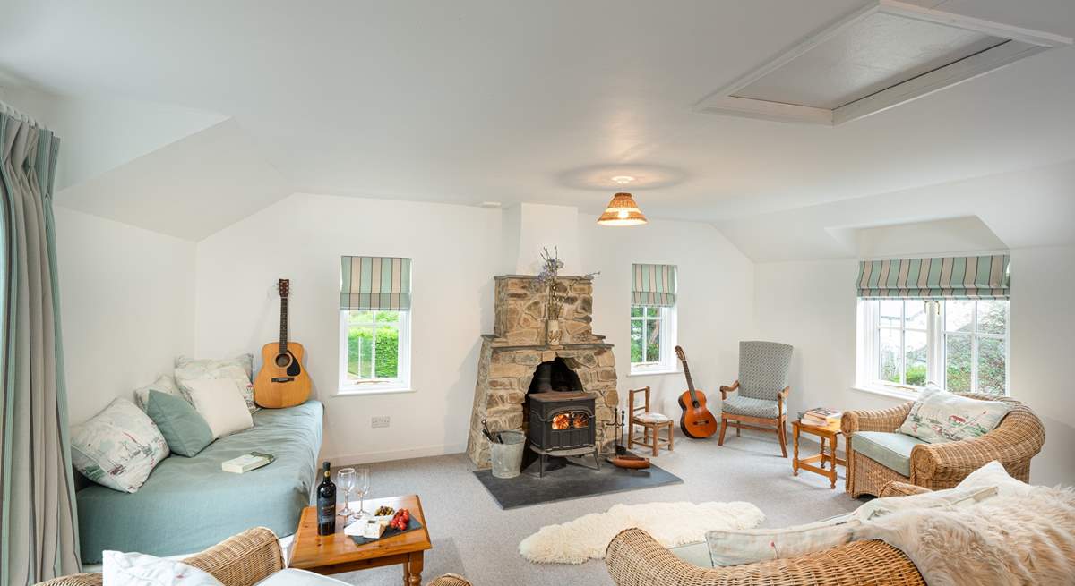 Light and spacious second sitting room with sea views and cosy wood-burner.