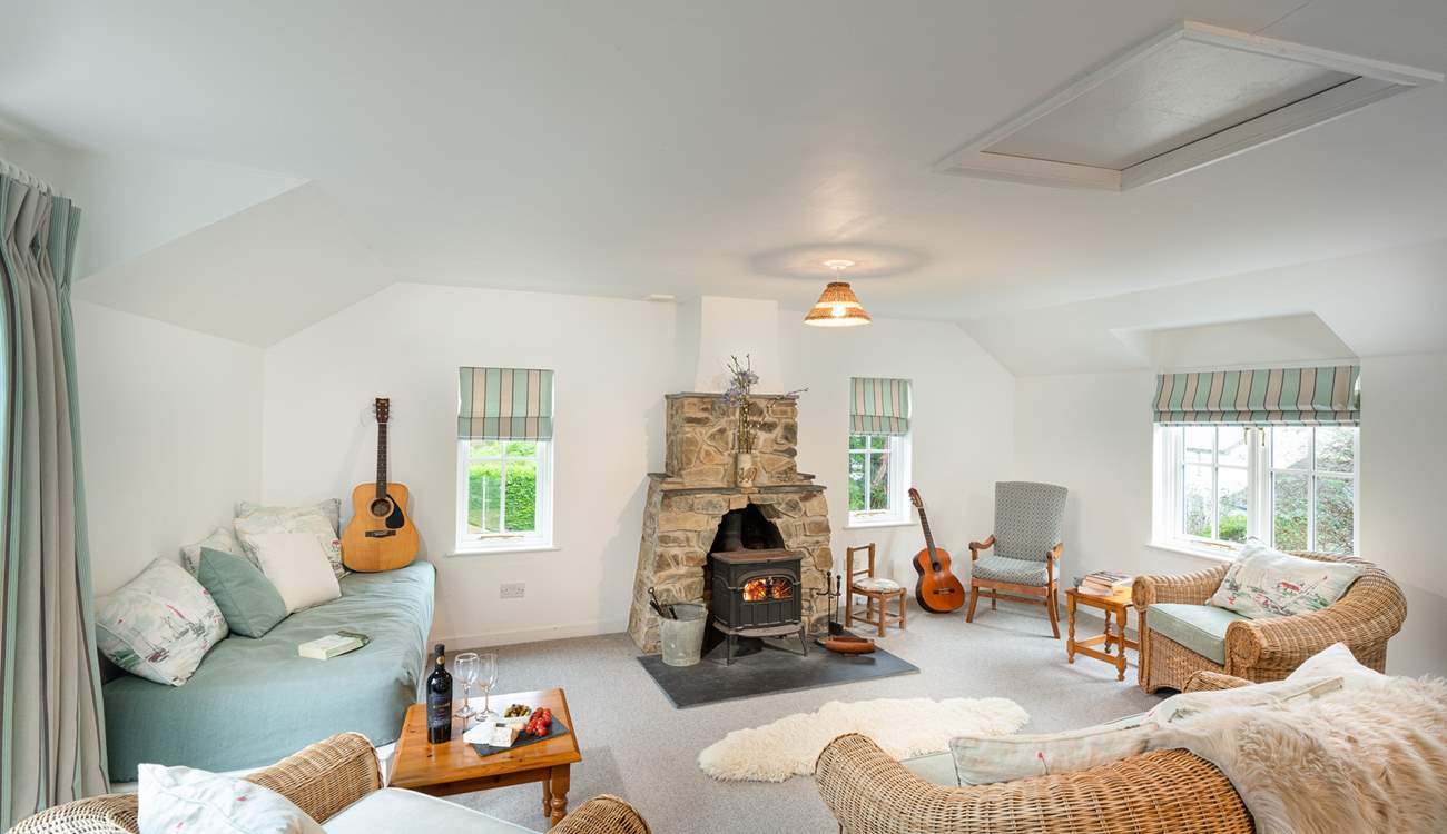 Light and spacious second sitting room with sea views and cosy wood-burner.