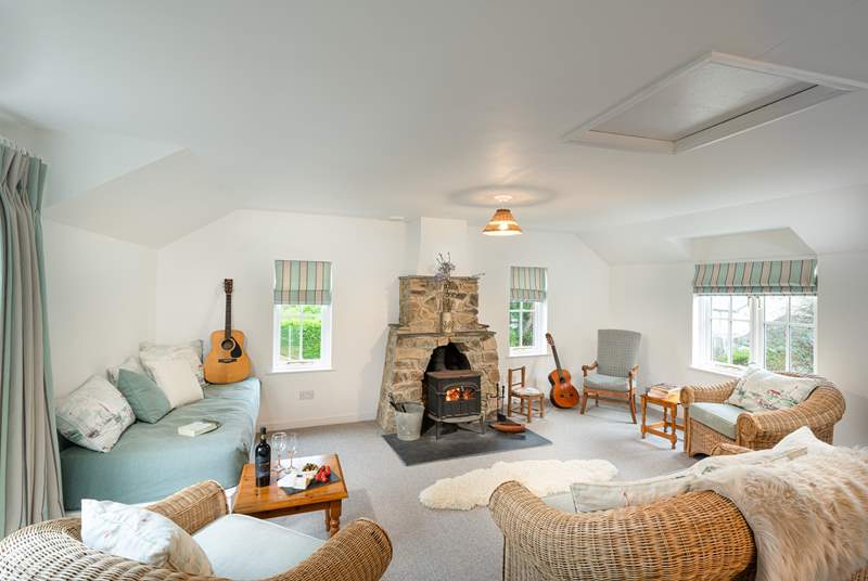 Light and spacious second sitting room with sea views and cosy wood-burner.