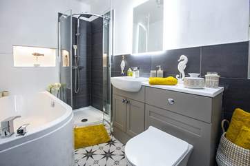 The stunning bathroom comes with waterfall shower and bath.