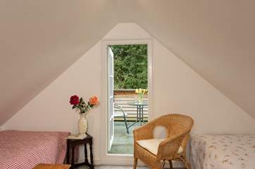 At the far end of the bedroom, there is a lovely seating-area with a door out to your private balcony.