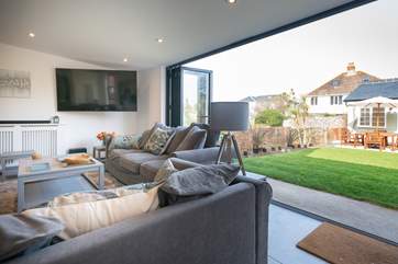 Sliding glass doors open up the home so you can spill out onto the garden and outhouse.