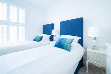 The light and airy third bedroom on the first floor with twin beds overlooks the garden.