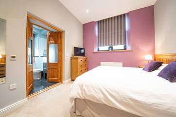 The spacious first bedroom on the ground floor boasts double doors...