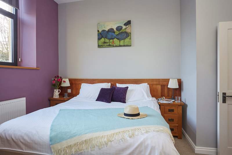 The spacious first bedroom on the ground floor boasts double doors...
