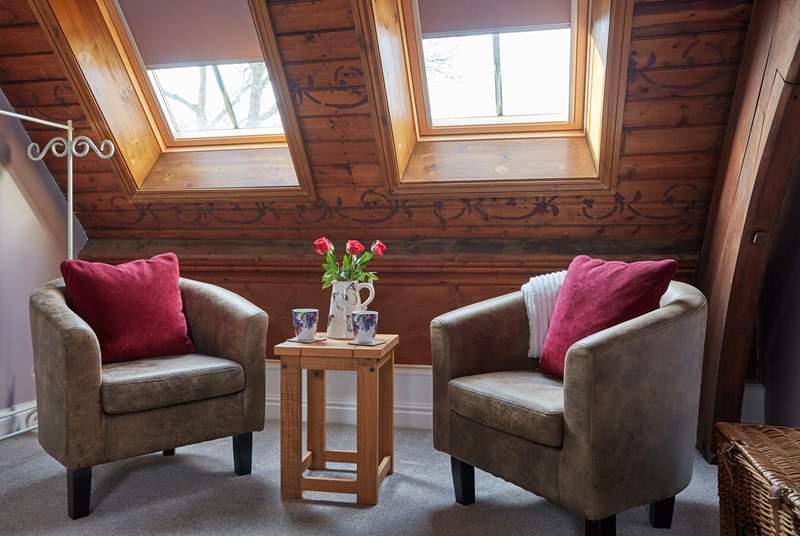 The main bedroom on the mezzanine has a seating area, start your day with a nice quiet cup of coffee.