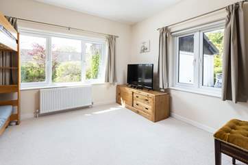 With lots of space and its own TV, the bunk room is a great place for the kids.