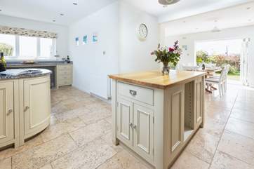 The central island divides the kitchen and dining area.
