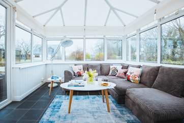 The conservatory offers a perfect space to relax and take in views of the garden and pool. The owners parents house at the end of the garden will be screened off.