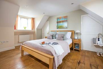 The main bedroom is both spacious and dual-aspect with views to the front and back of the house.