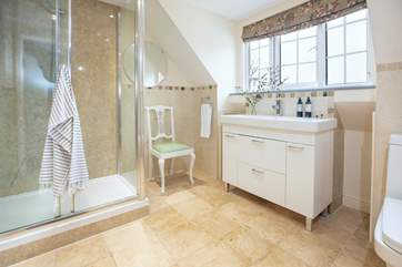 The generous shower en suite to the main bedroom is separated by Saloon doors.