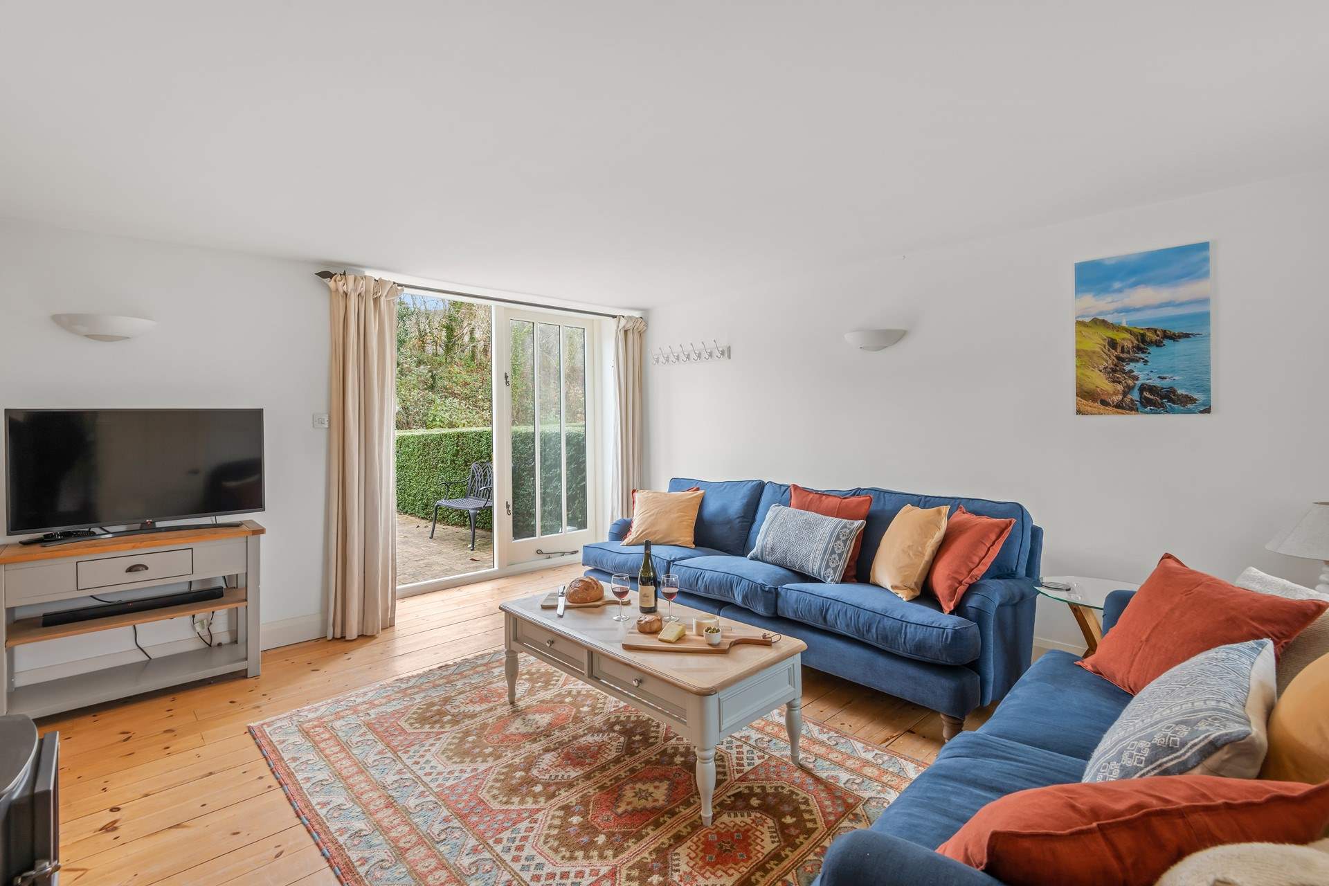 The sitting-room is simply beautiful and opens out on the enclosed patio-area.