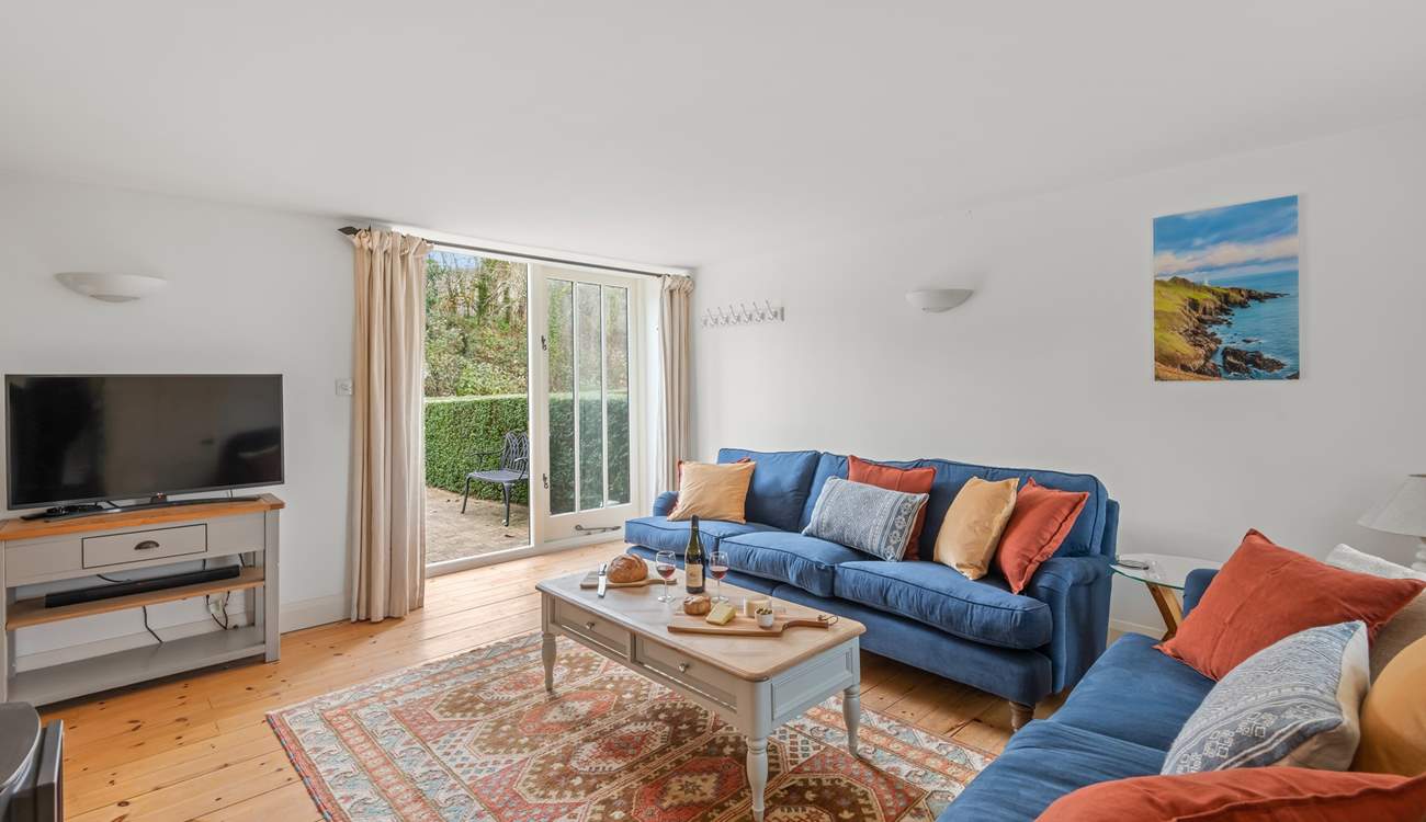 The sitting-room is simply beautiful and opens out on the enclosed patio-area.