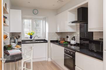 The kitchen overlooks the entrance and car parking.