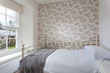 Pretty bedroom three has a day bed.