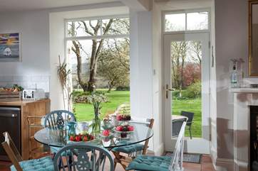 French doors lead out onto a private terrace overlooking the stunning gardens, perfect for morning coffee and al fresco evening drinks.