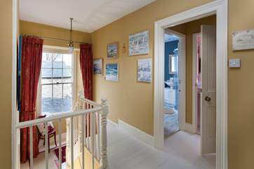 Stairs take you up to a lovely bright and sunny landing with dual-aspect views over the garden.