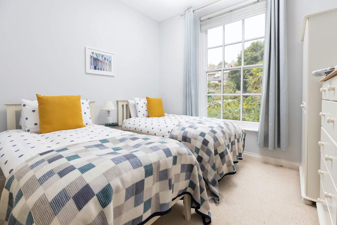 The twin bedroom is decorated in tranquil, calming tones.