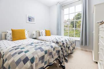 The twin bedroom is decorated with tranquil and calming tones.