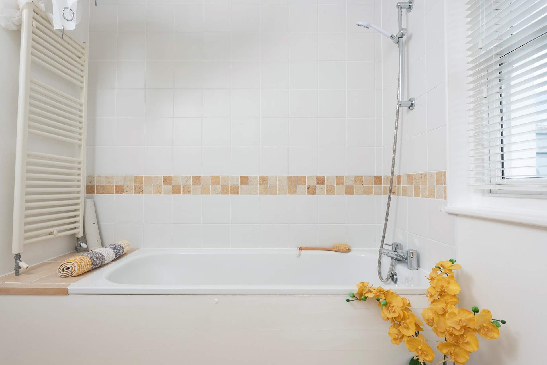 The family bathroom has a lovely bath and overhead shower. 