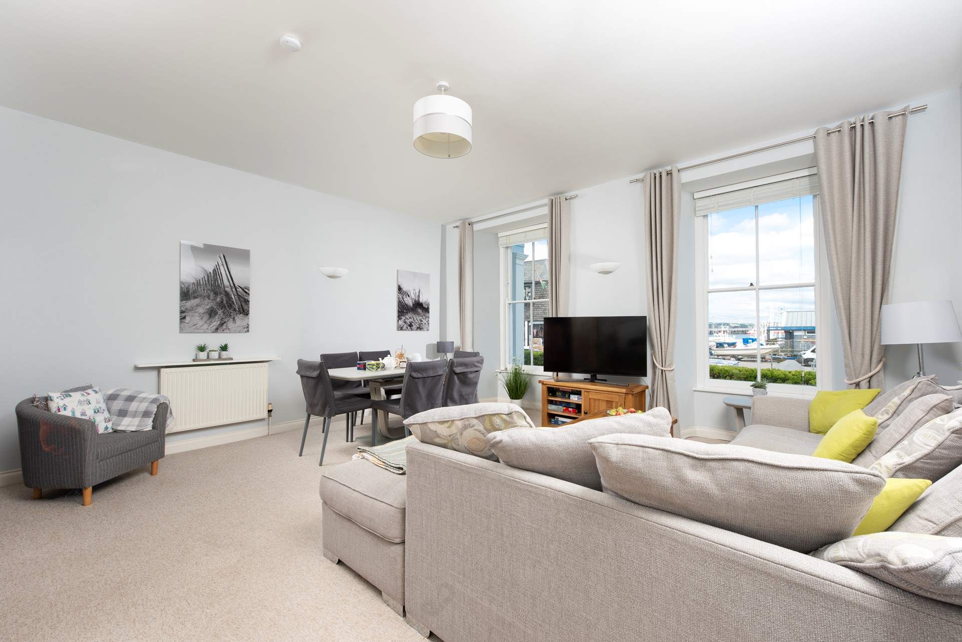 The stylish sitting-room is ever so comfortable, enjoy looking out towards the docks and sea at the ever-changing view. 