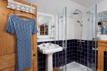 The stylish bathroom also has an enclosed shower.