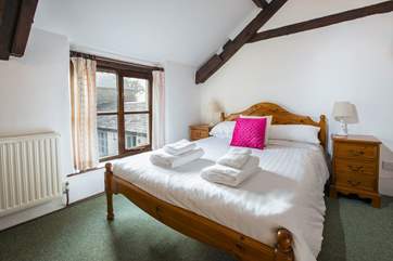 Bedroom 2 with wooden king-size bed.