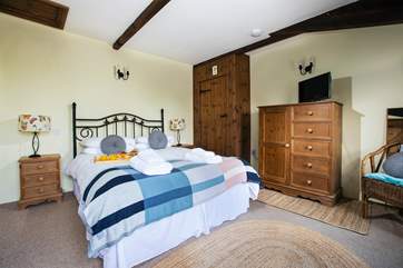 Bedroom 1 has an en suite bathroom and comfy king-size bed.