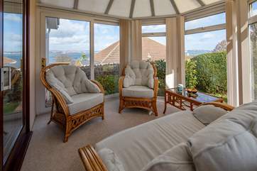 The conservatory is a great place to relax with a good book. What a stunning backdrop.
