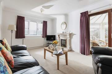 The cosy sitting room has beautiful sea views.