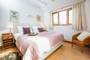 A spacious bedroom on the first floor with a 'zip and link' bed, adding flexibility to your stay.