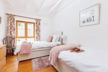 This 'zip and link' room can be made up as twins or a double bed.
The owners' house can be seen from the windows but this cottage faces away making for a private holiday.