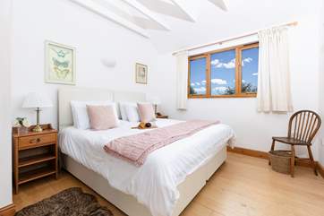 A spacious bedroom on the first floor with a 'zip and link' bed, adding flexibility to your stay.