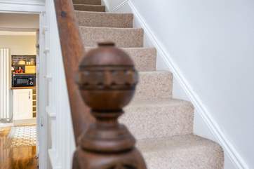 From the hallway climb the stairs to find the bedrooms or head to the kitchen to put the kettle on.