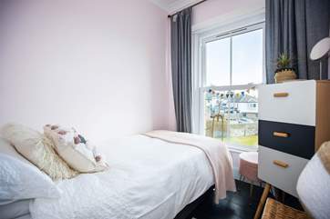 The pretty single bedroom also looks out across the garden to the sea.