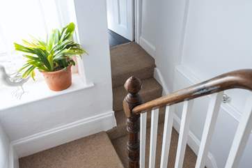 The split landing takes you to the bathroom straight ahead or rise up to the second floor to find bedroom four.