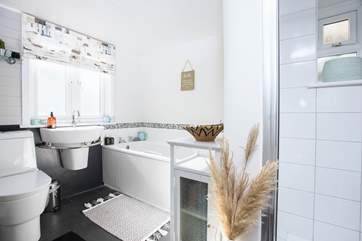 The first floor bathroom with shower cubicle and a bath for those bubbles.