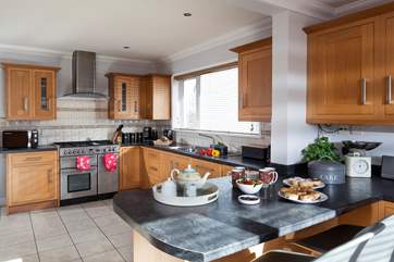 The stylish kitchen with room to cook and room to dine at the breakfast-bar.