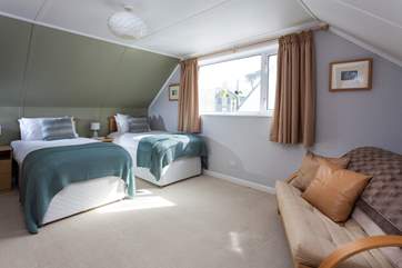 Twin beds in this spacious bedroom.