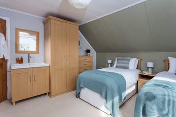 This bedroom has plenty of storage and a handy bedroom sink.