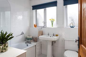 A lovely light bathroom for a soak in the tub.